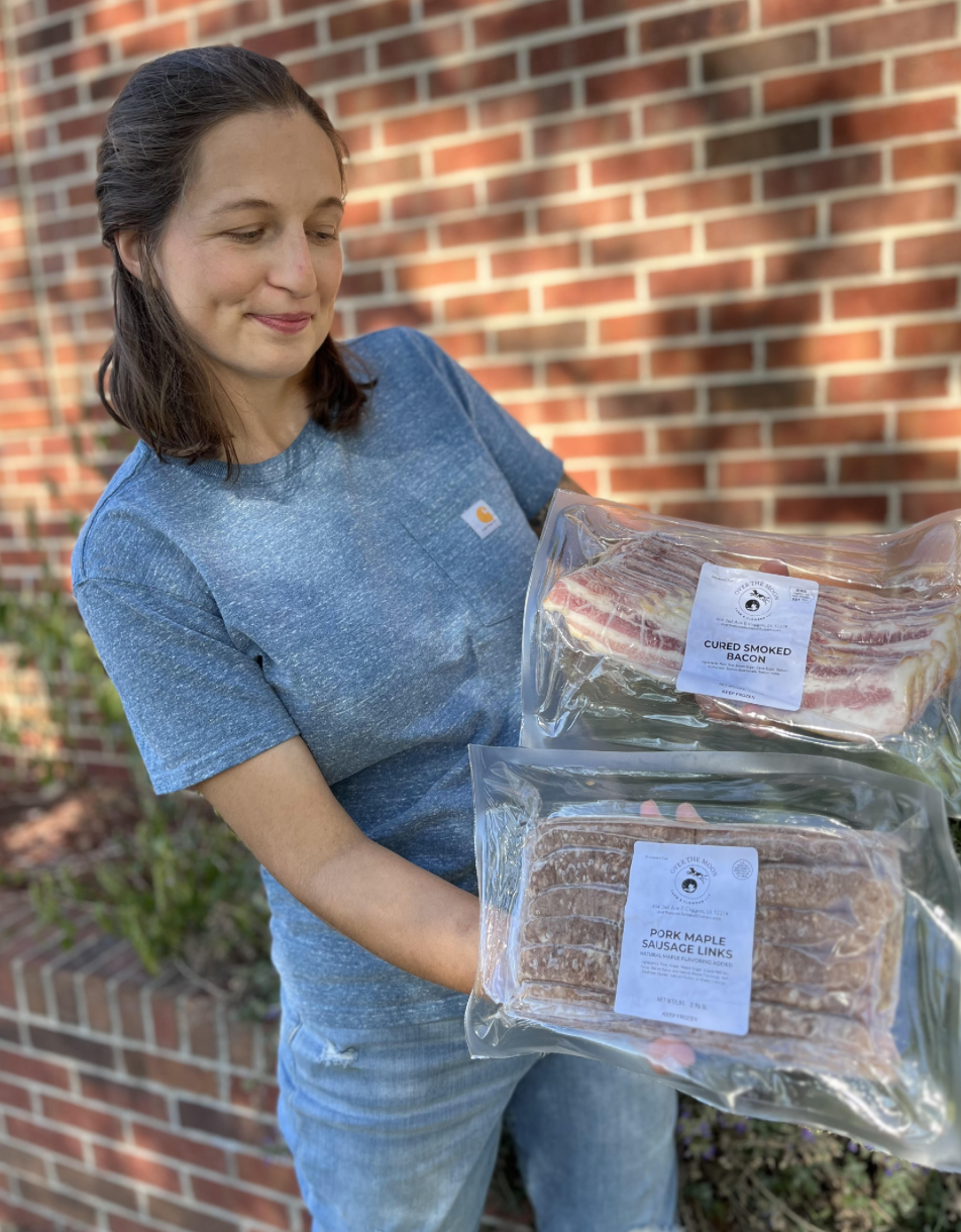 A women holding a pack of bacon