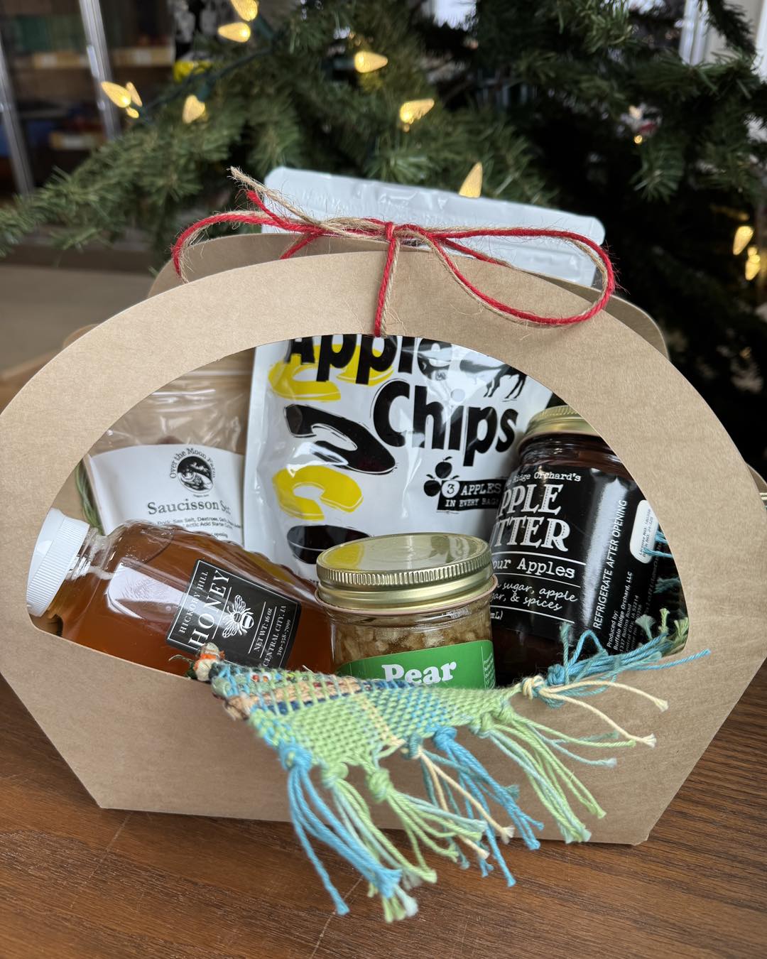 A basket of items including Honey, Pear Butter, Apple Butter, Apple Chips and more.