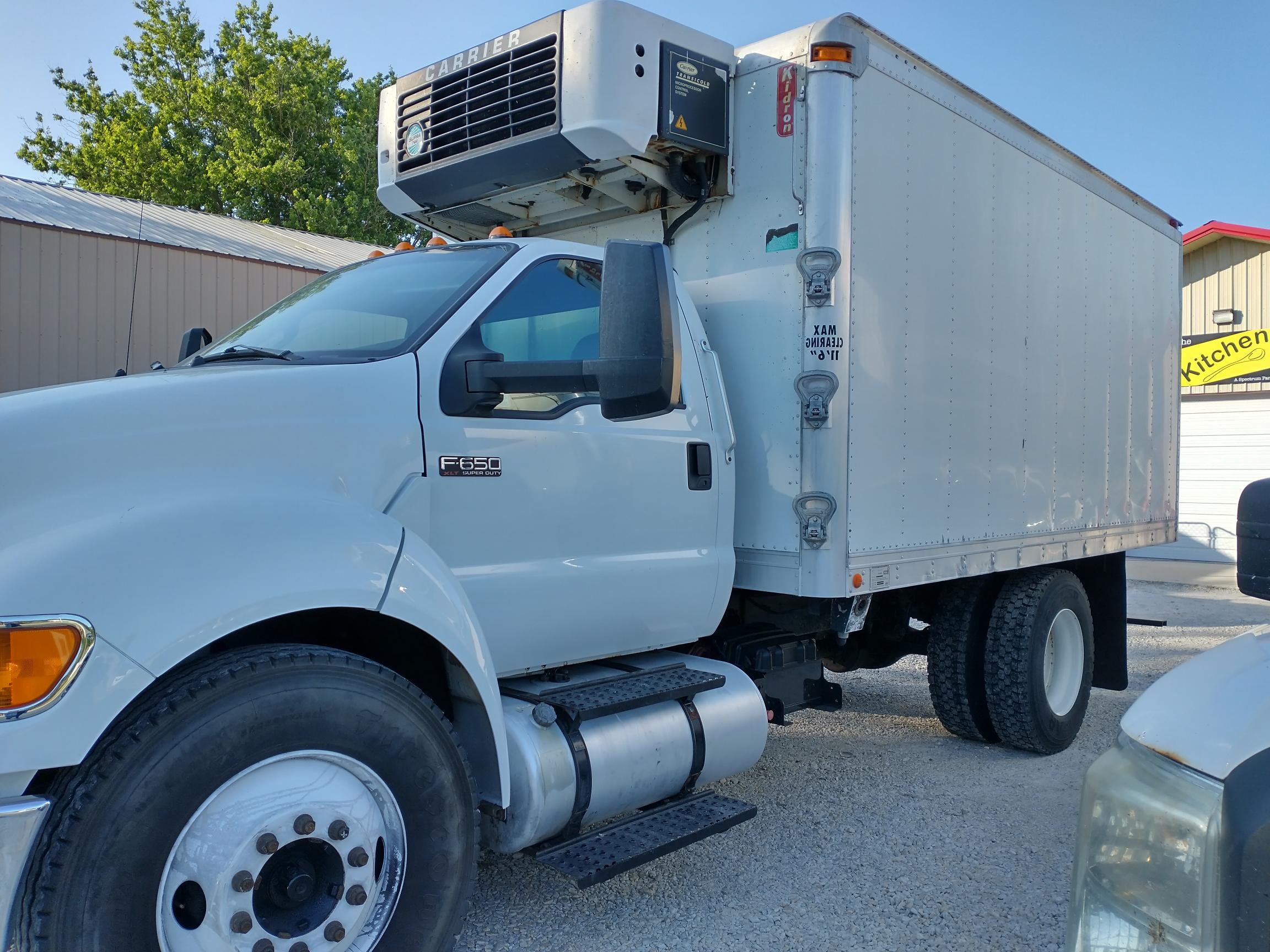 A white delivery truck stands ready.