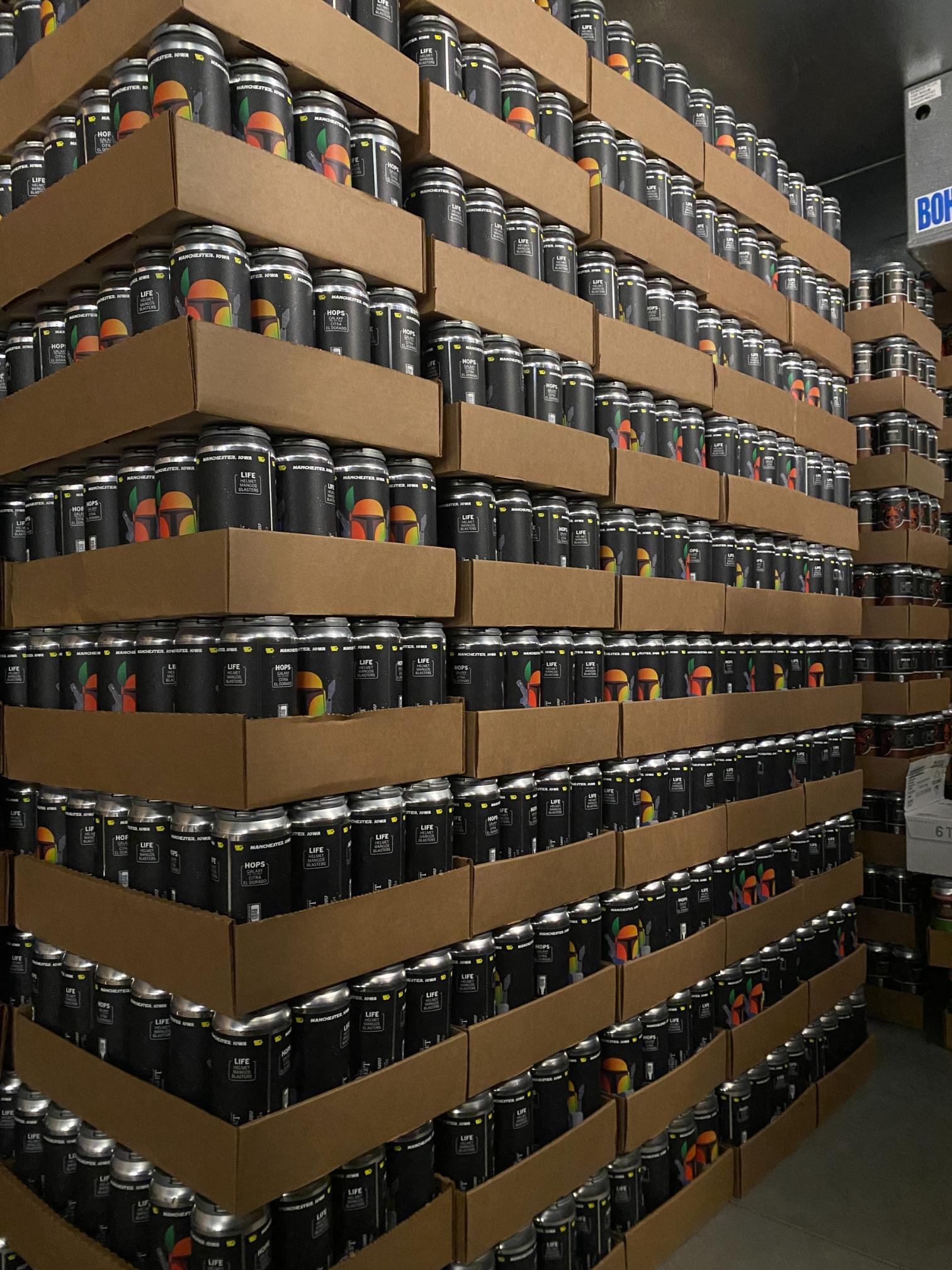 A big stack of cans stands ready for sale.