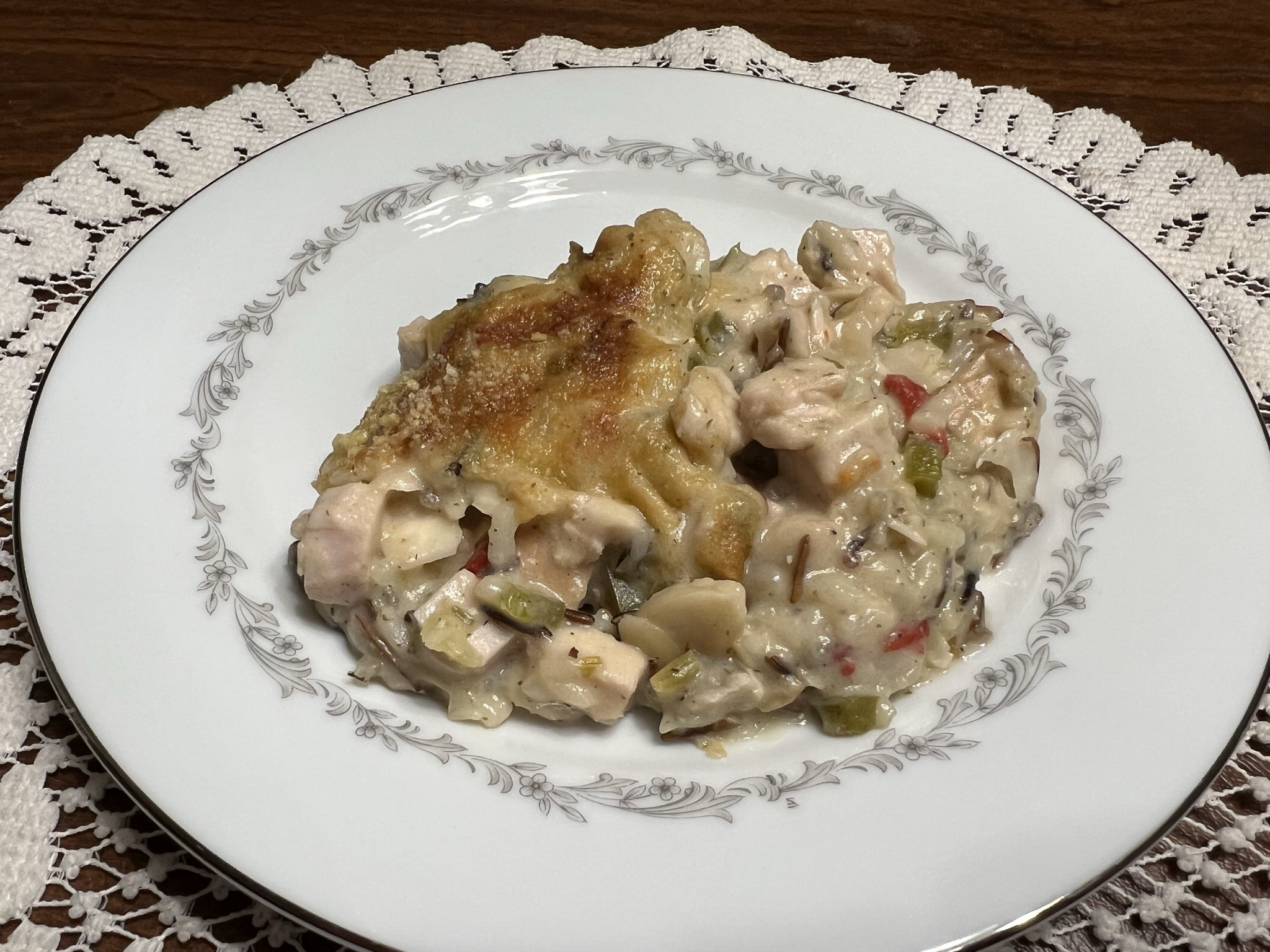 A plate of Turkey and Wild Rice Casserole sits ready to eat.