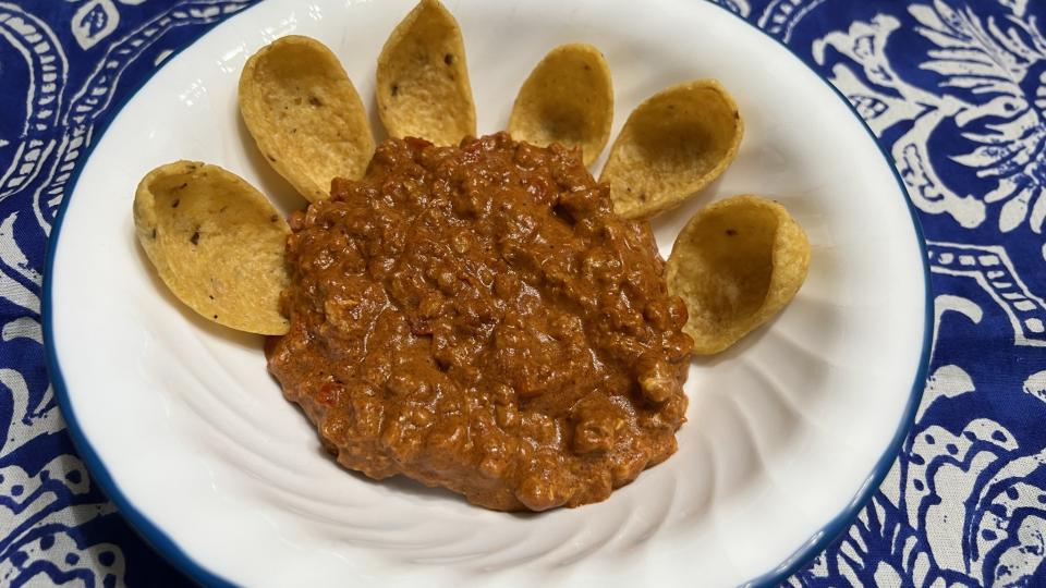 Corn chips sit ready to take on a pile of hot pork dip.