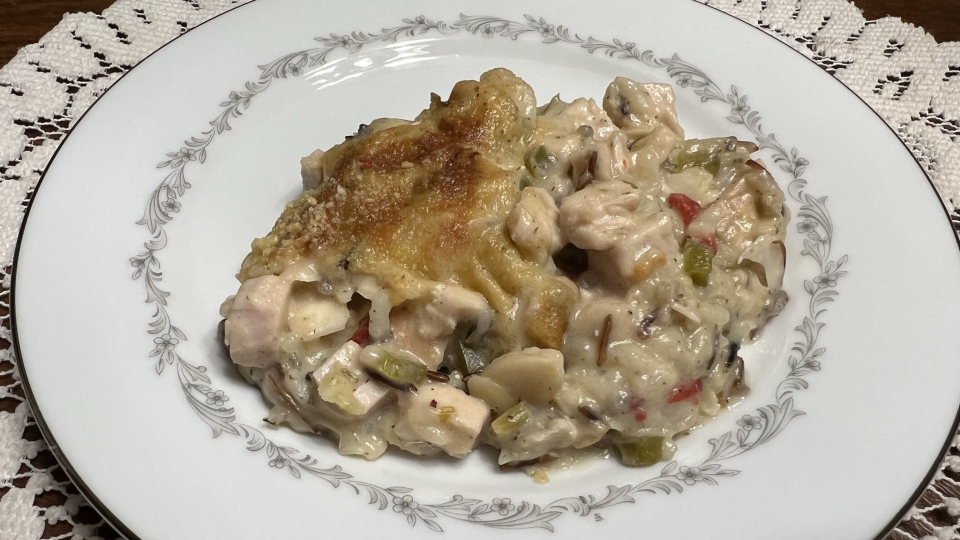 A plate of Turkey and Wild Rice Casserole sits ready to eat.