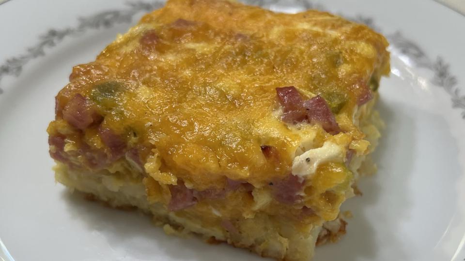 A piece of Wake Up Breakfast Casserole seats ready to eat.