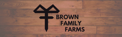 The words "Brown Family Farms" next to the farm's logo, on a weathered wooden background.