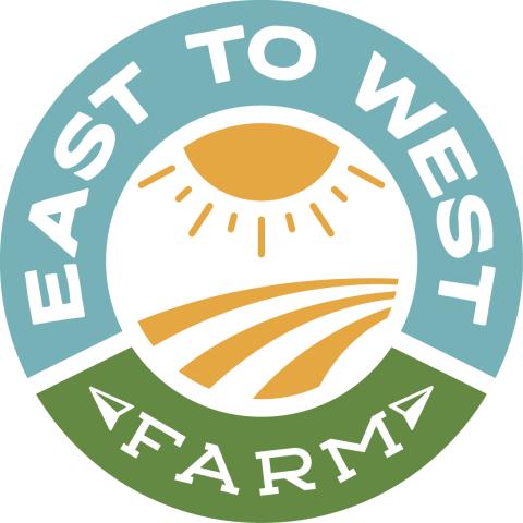 Bright cheerful circular logo for East to West Farm with Green and Blue text around the outside an a yellow sun over a yellow field in the center. 