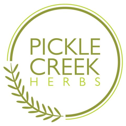Pickle Creek Herbs logo with text inside circle overlaid with grain head design