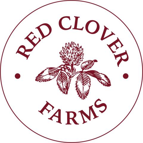 red clover with text above and below inside a red circle with a thin outline