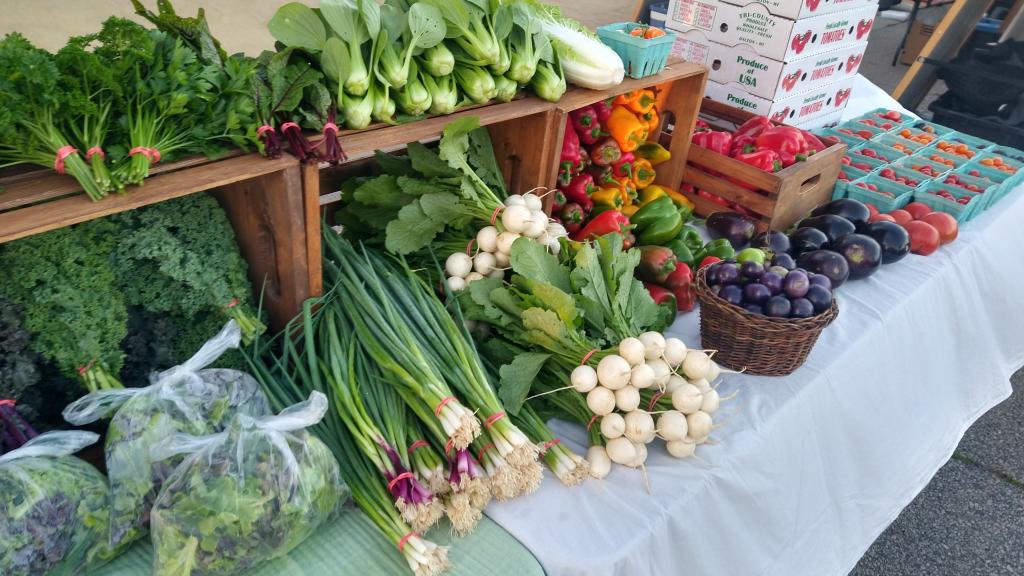 Colorful vegetables on display at farmers market.