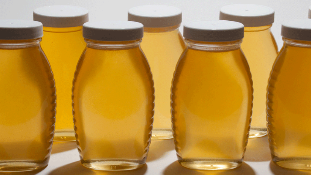 Jars of honey in a row.