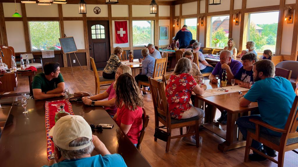 friends gathering at the tasting room sampling wine cheese and chocolate on opening day.