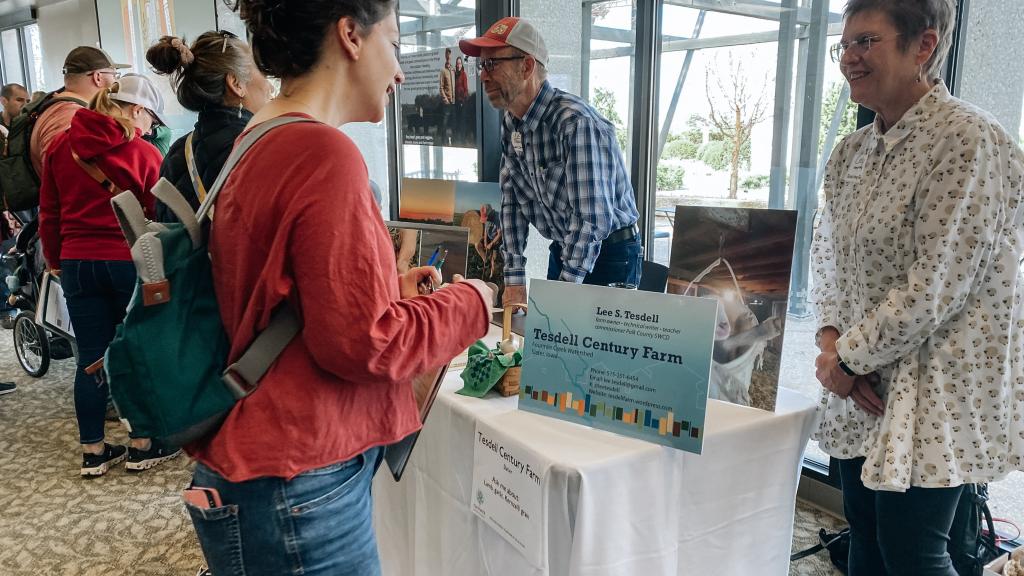 Seed and Source event, farmer talking to a woman