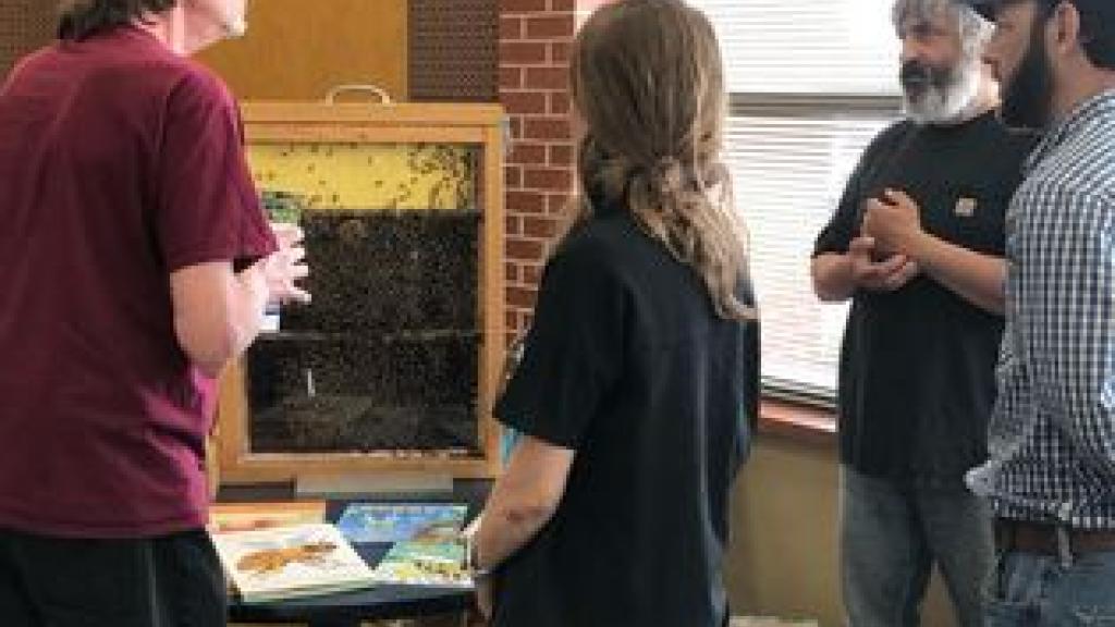 Beekeeper talking to attendees