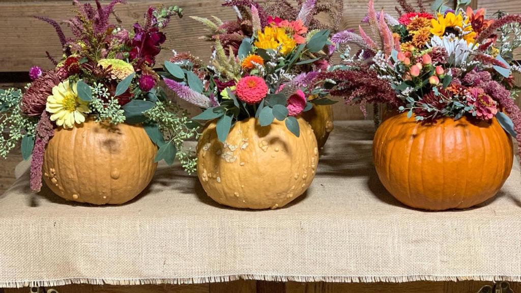 small floral arrangements inside pumpkins for fall displays