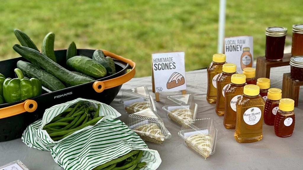 produce and local honey on a market table