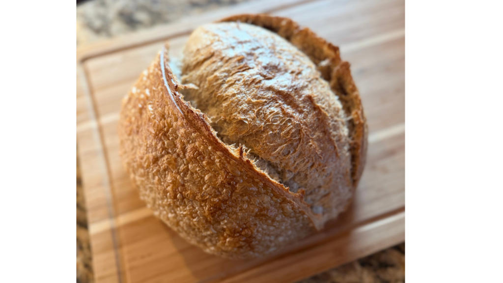 Loaf of sourdough on wood cutting board