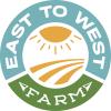 Bright cheerful circular logo for East to West Farm with Green and Blue text around the outside an a yellow sun over a yellow field in the center. 