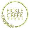 Pickle Creek Herbs logo with text inside circle overlaid with grain head design